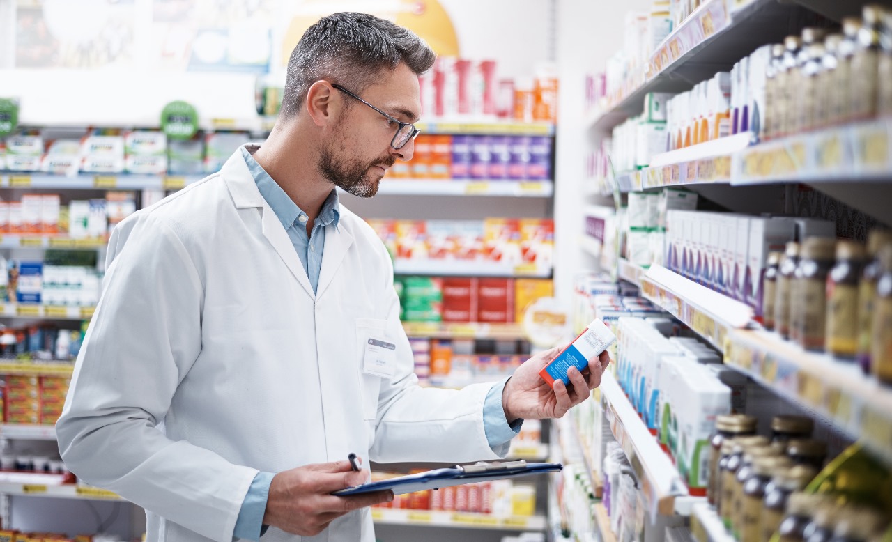 A Pharmacist analyzing a medicine packaging a medical store